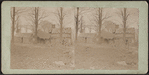 View of small huts with thatched roofs.