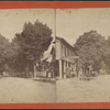 Street view in Red Hook, N.Y. including a hat, cap, boot and shoe store.