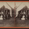 Group portrait of campers in front of a tent.