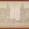 Group of men standing in line in front of building.