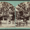 View of a carriage in front of a house.