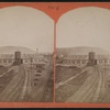 Erie Railroad yard, including view of a round house and watertower.