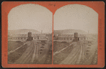 Erie Railroad yard, including view of a round house and watertower.