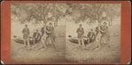 Group of men resting under the tree.