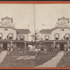 View of people standing in the verandah and one man standing on the roof.