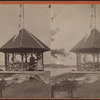Three women in small lakeside gazebo.
