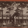 Two women in front of small residential building.
