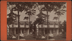 Two women in front of small residential building.