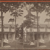 Two women in front of small residential building.