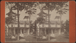 Two women in front of small residential building.