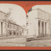View of a building with four men in front.
