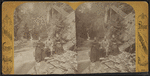 Two women and a man sitting on the rocks in Glen Cathedral.