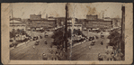 Scenery view of buildings, horse carriages and trolley.