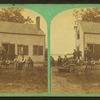 Group portrait of people in front of a house.