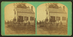 Group portrait of people in front of a house.