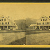 Group portrait of people on the porch of a big house.
