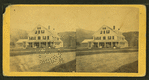 Group portrait of people on the porch of a big house.