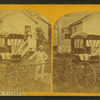 View of man standing next to a buggy in Cardington.