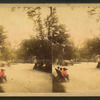 People on benches in a park.