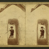 View of a child with a shovel standing behind a tunnel of snow in front of a house.