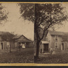 View of two homes, couples standing out front.