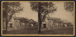 View of two homes, couples standing out front.