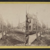Congress Park, Bradford, Pa. [View down a street lined with row houses, oil derrick at the end of the street.]