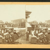 Men and baggage on station platform.