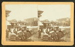 Men and baggage on station platform.