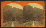 Railroad tunnel and tracks through mountain.