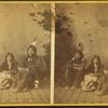 Studio portrait of three Native American children in traditional clothing.