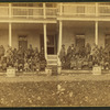 Group portrait of Native American students on the steps of the United States Indian Industrial Training School.