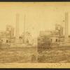 Industrial building with inclined plane and large smokestack.