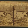Residence of Captain West, showing debris drifted up on a back street.