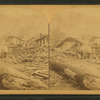 A common sight on Railroad Street, showing where so many frame buildings were crushed into piles of rubbish by floating logs, &c.