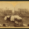 A view taken from the rear of the P. R. R. depot. In the middle ground are seen the stores and offices of the Cambria Iron Co., and in the foreground are coffins and bodies just arrived from the morgues and ready for shipment.