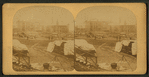 A view taken from the rear of the P. R. R. depot. In the middle ground are seen the stores and offices of the Cambria Iron Co., and in the foreground are coffins and bodies just arrived from the morgues and ready for shipment.