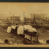 A view taken from the rear of the P. R. R. depot. In the middle ground are seen the stores and offices of the Cambria Iron Co., and in the foreground are coffins and bodies just arrived from the morgues and ready for shipment.