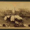 A view taken from the rear of the P. R. R. depot. In the middle ground are seen the stores and offices of the Cambria Iron Co., and in the foreground are coffins and bodies just arrived from the morgues and ready for shipment.