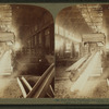 Steel works, Pittsburgh, Pa., beam of hot iron in rolling mill, drawn out [00?] feet long.