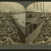 Trains loaded with pig iron, showing coke ovens on left and Monongahela River on right, Pittsburg, Pa., U.S.A.