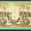 Group of women in front of house.
