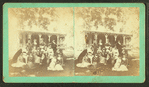 Group of women in front of house.