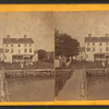 Group playing croquet in front of house or boarding house.