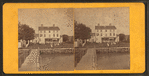 Group playing croquet in front of house or boarding house.