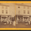 Group playing croquet in front of house or boarding house.