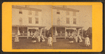Group playing croquet in front of house or boarding house.