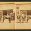 Group in a buggy on a city street.