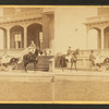 People in coach with African American coachman, in front of house.