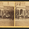 Coachman holding the reins of horse with people in coach.